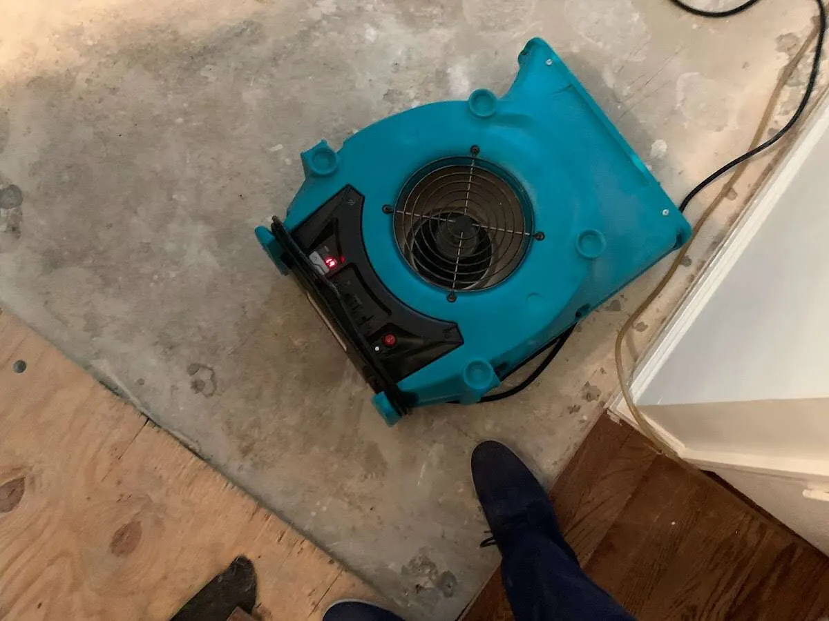 Air mover drying subfloor during Leak Detection & Repair in Weiser